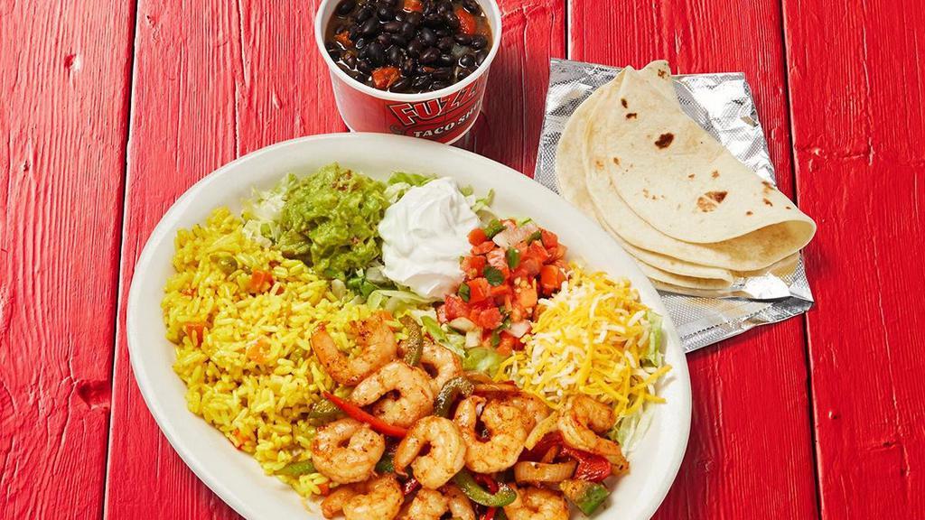 Fajita Shrimp Plate · Served with three flour tortillas, guacamole, lettuce, sour cream, shredded cheese, pico de gallo, grilled peppers and onions with your choice of 2 sides.. {GF}, {DF - remove shredded cheese and sour cream}