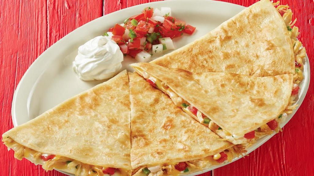 Shredded Chicken Quesadilla · *FAN FAVORITE - Grilled flour tortillas stuffed with shredded chicken, shredded cheese, pico de gallo, and garlic sauce. Served with a side of sour cream and pico de gallo.