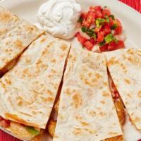 Grilled Shrimp Quesadilla · Grilled flour tortillas stuffed with grilled shrimp, shredded cheese, pico de gallo, and gar...