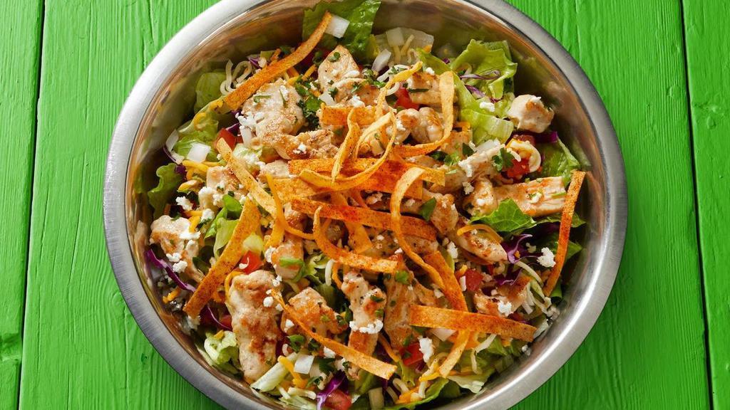 Fajita Chicken Salad · *FAN FAVORITE - Fajita chicken served on a fresh lettuce blend topped with tomatoes, onions, shredded cheese, feta, cilantro, tortilla strips, and your choice of dressing.. {DF - with Fire-Roasted Salsa dressing and remove shredded and feta cheese}