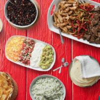 Large Fajita Family Meal - Serves 6-8 · Includes choice of meat with veggies, two sides, sopapilla bites, and all the fixings - tort...