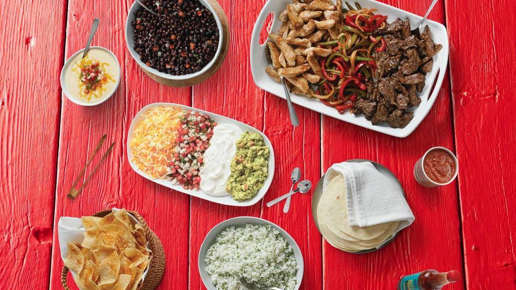 Regular Fajita Family Meal - Serves 4-6 · Includes choice of meat with veggies, two sides, sopapilla bites, and all the fixings - tortillas, guacamole, lettuce, sour cream, shredded cheese.