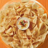 Chips & Queso Party Tray · One quart of creamy queso & freshly made tortilla chips. Feeds 8-10