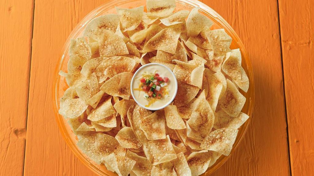 Chips & Queso Party Tray · One quart of creamy queso & freshly made tortilla chips. Feeds 8-10