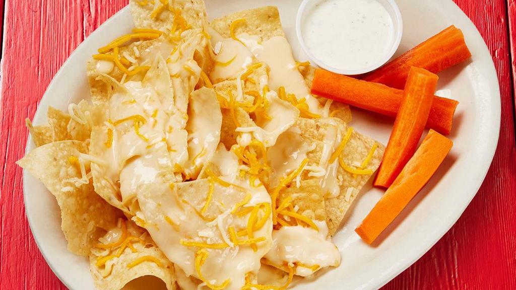 Kid'S Cheese Nachos · Pile of fresh tortilla chips topped with shredded cheese and queso, and served with a snack.. {GF - with carrots & ranch}