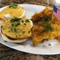 Classic Eggs Benedict · Two poached eggs with Canadian bacon on English muffin topped with hollandaise sauce.