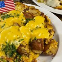 Farmer'S Breakfast · Three eggs scrambled with home fries, onion, green peppers, apple wood bacon and cheese serv...
