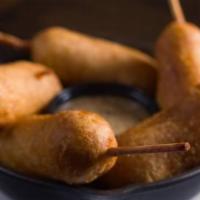 Mini Angus Beef Corndogs · Hand-battered and served with dark beer mustard.