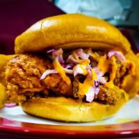 Tandoori Fried Chicken Sandwich · Spiced yogurt marinated chicken roasted then deep-fried golden brown topped with pickles, sw...