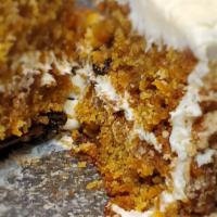 Carrot Cake · Spiced three layer cake with walnuts, raisins and cream cheese frosting.