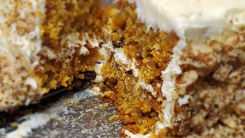 Carrot Cake · Spiced three layer cake with walnuts, raisins and cream cheese frosting.