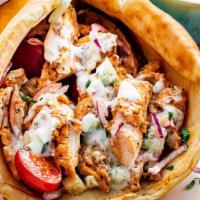 Chicken Gyro Combo  · Sliced grilled chicken set on pita bread topped with lettuce, tomatoes, onions, and tzatziki...