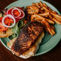 Salmon Sandwich · 6oz Filet of Atlantic Salmon. Served on Garlic Coco Bread Bun with Lettuce, Tomatoes, Red On...