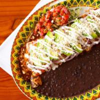 Hacienda Burrito · Large flour tortilla stuffed with Spanish rice, grilled Chicken and skirt steak, roasted cor...