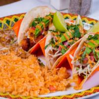Spicy Shrimp Tacos · Three soft flour tortillas filled with cajun grilled shrimp in a spicy chile lime sauce and ...