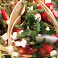 Oaxaca Tacos · Three soft corn tortillas filled with carne asada, pico de gallo, avocado salsa verde, radis...