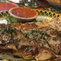 Chicken Parmesan · Fried Chicken, marinara sauce and melted Mozzarella Cheese in a large flour tortilla. Served...