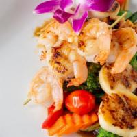Jumbo Scallops And Shrimps · Pan seared scallops and shrimps served with sauteed veggies with black pepper sauce. Served ...