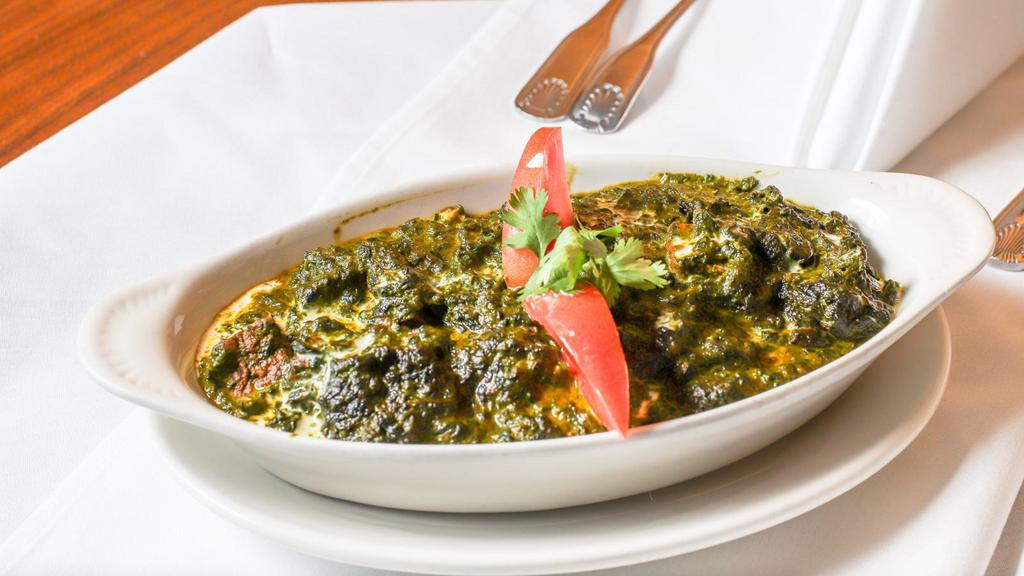 #99. Palak Paneer · Cubes of homemade paneer (curd cheese) in creamed spinach and fresh spices.