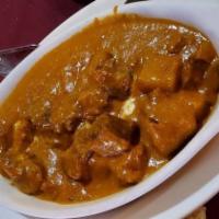#62. Goat Curry · Goat cooked with ginger, garlic, onion, tomato and our special curry sauce.