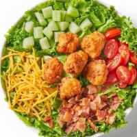 Fried Chicken Club Salad · Fried chicken nuggets, leaf lettuce, tomato, cucumber, bacon and shredded cheddar. Recommend...