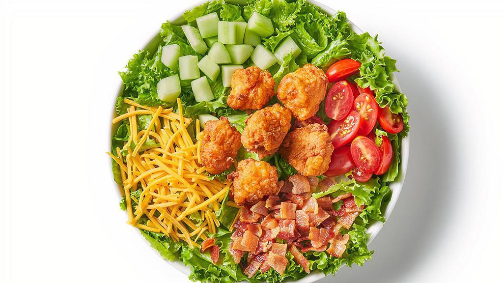 Fried Chicken Club Salad · Fried chicken nuggets, leaf lettuce, tomato, cucumber, bacon and shredded cheddar. Recommended with ranch dressing.
