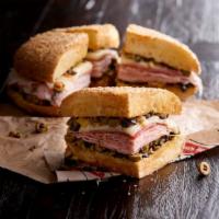 Whole Muffaletta · Preium meats with provolone cheese, olive mix on sesame seed muffaletta bread.  Served with ...