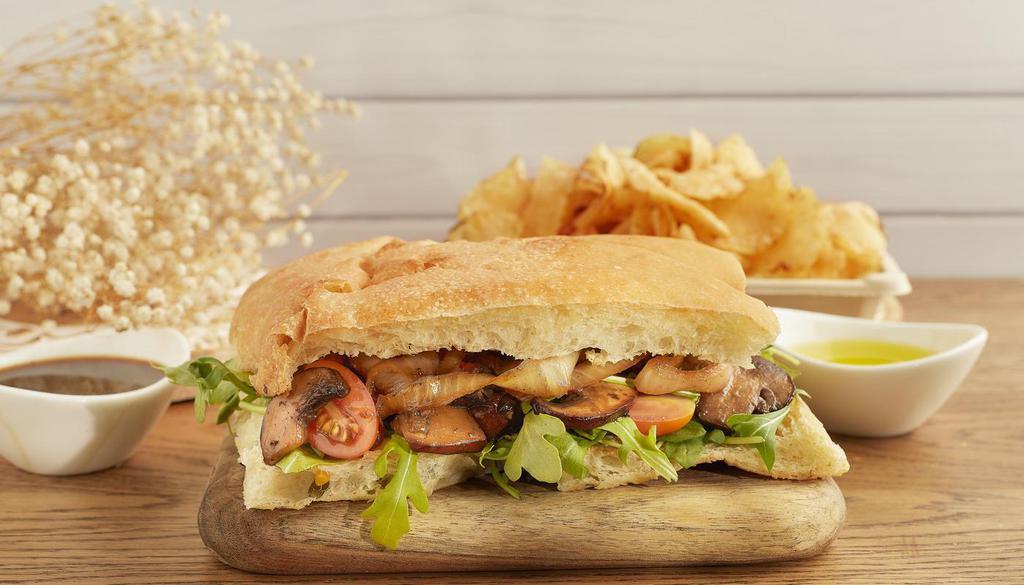 Panini · Bread made with 100% organic wheat flour with our special roasted mushroom with caramelized onions + tomato cherry + arugula, and side of potato chips