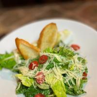 Caesar Salad  · Romaine lettuce with cherry tomato, croutons, shaved parmesan and traditional Caesar dressing