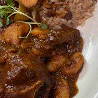 Spicy Hill Oxtails · Slow cooked to perfection with rice and peas, sautéed cabbage and plantains