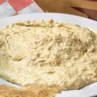 Hummus · Vegan.  Cooked & Blended Garbanzo Beans Mixed With Sesame Seed Paste,  Lemon Juice & Spices....