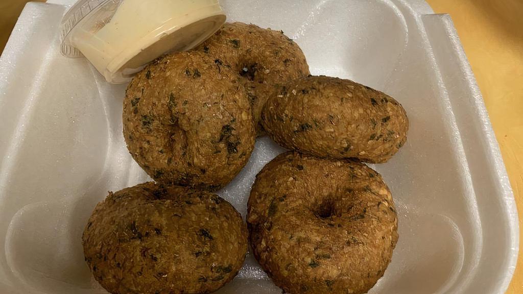 Falafel (5 Pcs) · Vegan.  Delicious Patties Of Ground Cooked Garbanzo Beans Mixed With A Special Blend Of Spices,  Fried To Perfection,  Served With Your Choice Of Sauce