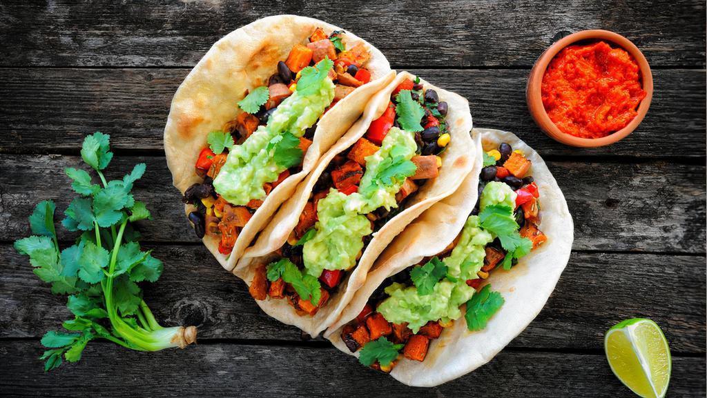 Vegan Tacos · Vegetarian. Three tacos packed with black beans, Pico de Gallo, avocado, tofu, shredded lettuce, corn and covered with tahini sauce and lime wedges
