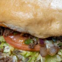 Howards Philly Sandwich · Sirloin steak chopped and grilled with red onions and bell peppers, melted swiss cheese, may...