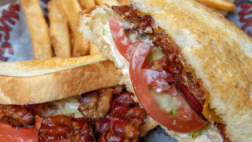L.T.C. Sandwich · Hickory smoked bacon, lettuce, tomatoes, cheddar cheese, and mayo served on sliced sourdough bread.
