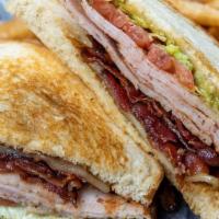 Turkey Club Sandwich · Grilled smoked turkey breast, hickory smoked bacon, pepper jack, guacamole, lettuce and toma...