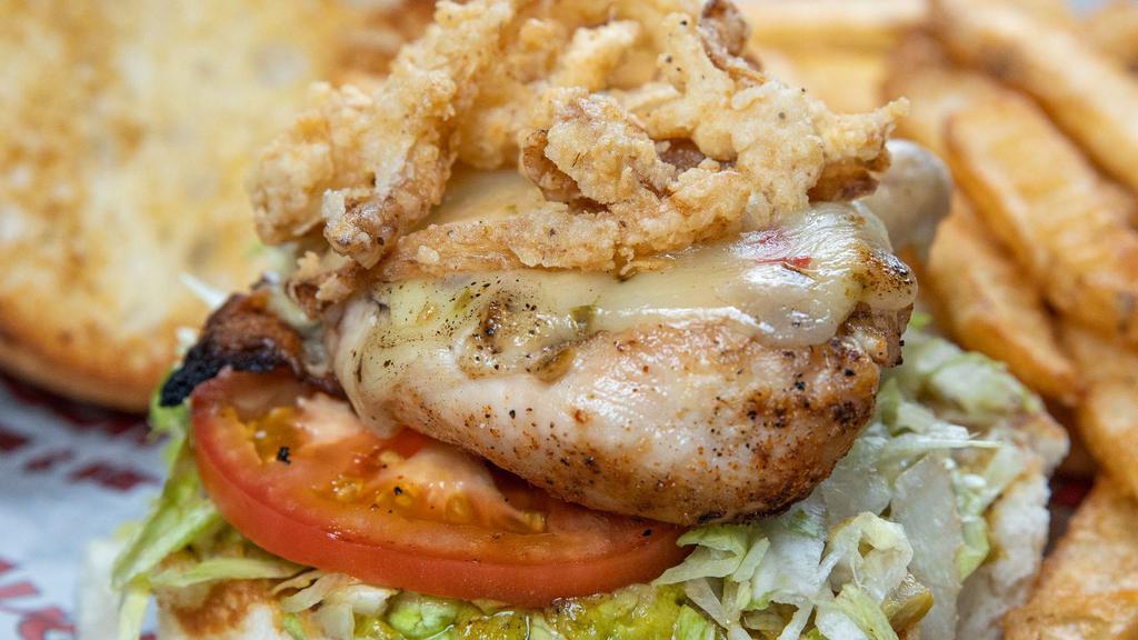 Holy Guacamole Chicken Sandwich · Grilled chicken breast topped with melted pepper jack cheese and fried onion strings, dressed with guacamole, lettuce and tomato.