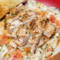 Rajun Cajun Pasta · Grilled cajun chicken breast served on a bed of penne pasta tossed in alfredo sauce, topped ...