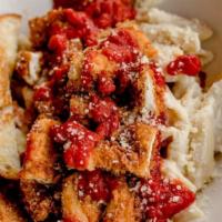 Parmesan Chicken Marinara · Fried chicken tenders served on a bed of penne pasta tossed in alfredo sauce, topped with ma...