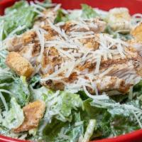Chicken Caesar Salad · Grilled chicken breast on a bed of romaine lettuce tossed in a creamy Caesar dressing topped...
