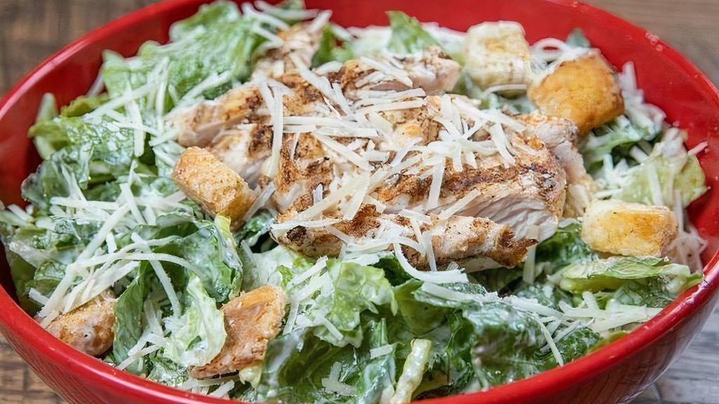 Chicken Caesar Salad · Grilled chicken breast on a bed of romaine lettuce tossed in a creamy Caesar dressing topped with fresh grated parmesan cheese and croutons. Make it shrimp caesar for 1.00.