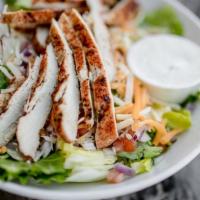 Rajun Hester Cajun Salad · Grilled cajun seasoned chicken served over a bed of our fresh salad mix topped with mixed ch...
