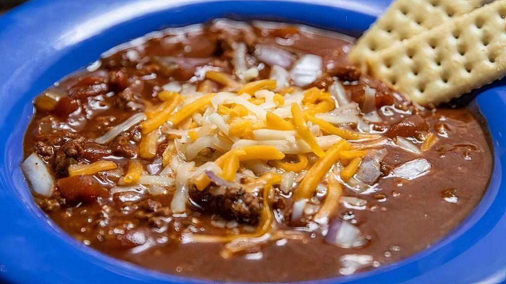 Chili · Slow cooked house made beef chili topped with onions and shredded cheese.
