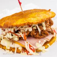 Patacones · Two slices of crispy fried plantain, shredded beef, ham, cheese and sauces.