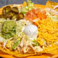 Super Nachos (Ground Beef Or Shredded Chicken)  · Lettuce, cheddar cheese, diced tomatoes, jalapenos, guacamole, & sour cream. *topped with yo...