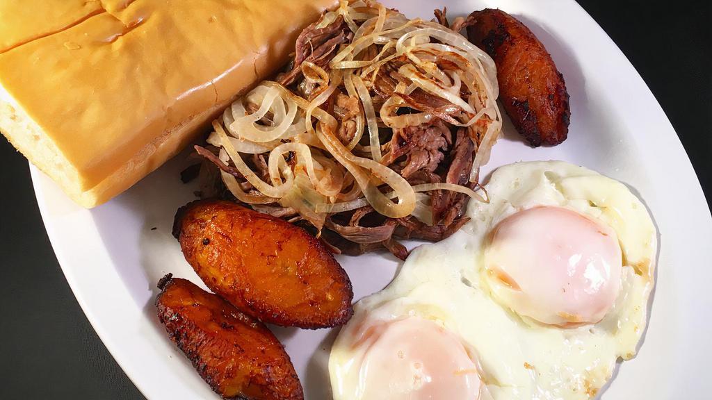 Vaca Frita · Two fried eggs, sweet plantains and toast.