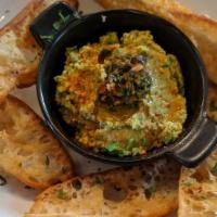 Small Green Goddess Hummus · Blended chick peas & tahini loaded with fresh herbs, lemon & garlic; served with house crost...