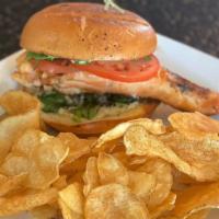 Grilled Salmon Sandwich · Char-grilled salmon, capers, arugula, tomato & basil aioli on toasted brioche; served with p...