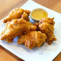 Chicken Wings · Deep- fried chicken wings served with sauce.