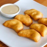 Thai Donuts · Deep fried Thai donuts served with condensed milk.